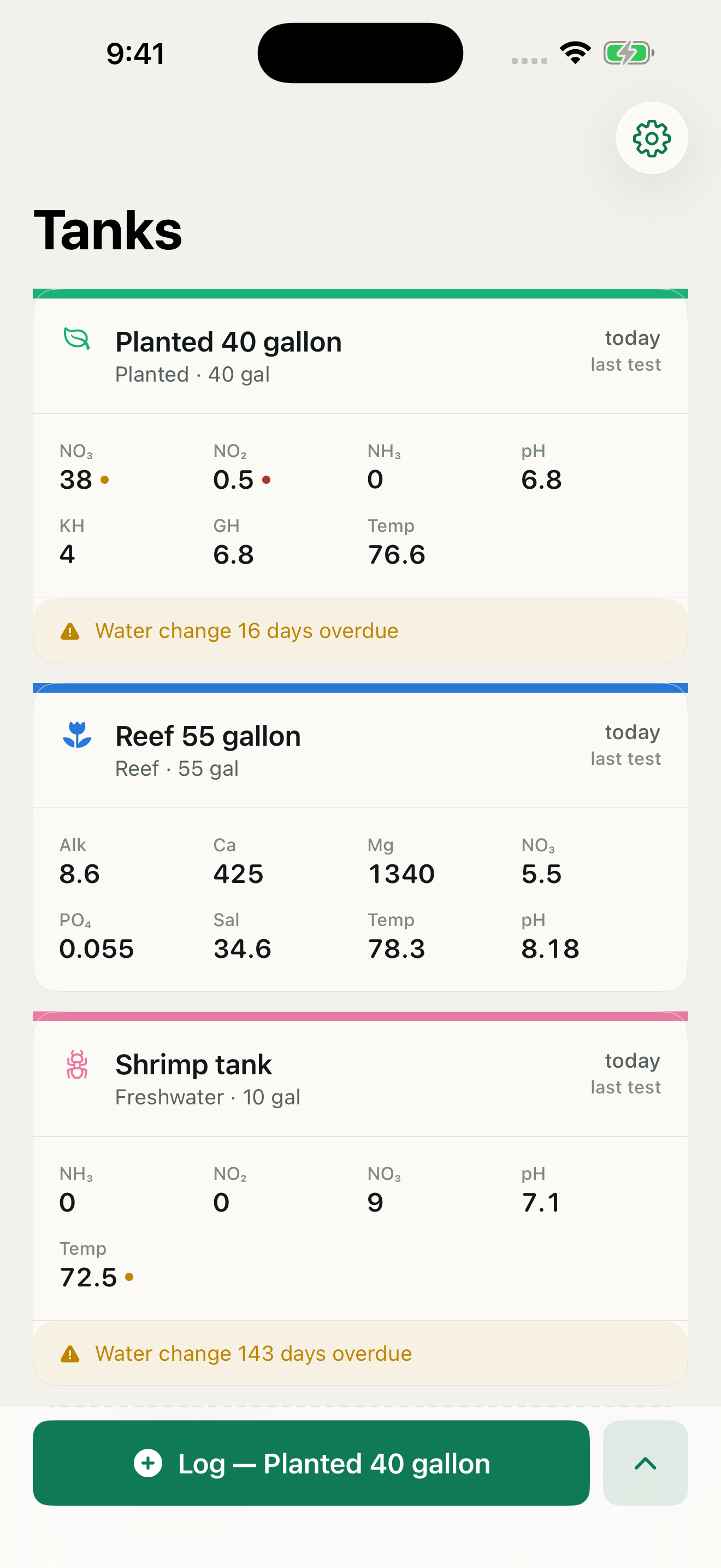 The tank list: three tanks, each with a coloured identity band, its latest readings and a status dot on anything out of range.
